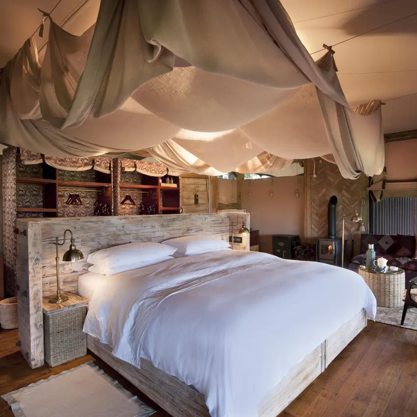 Spacious bedroom with draped canopy bed and seating area, Somalisa Acacia, Hwange National Park, Zimbabwe