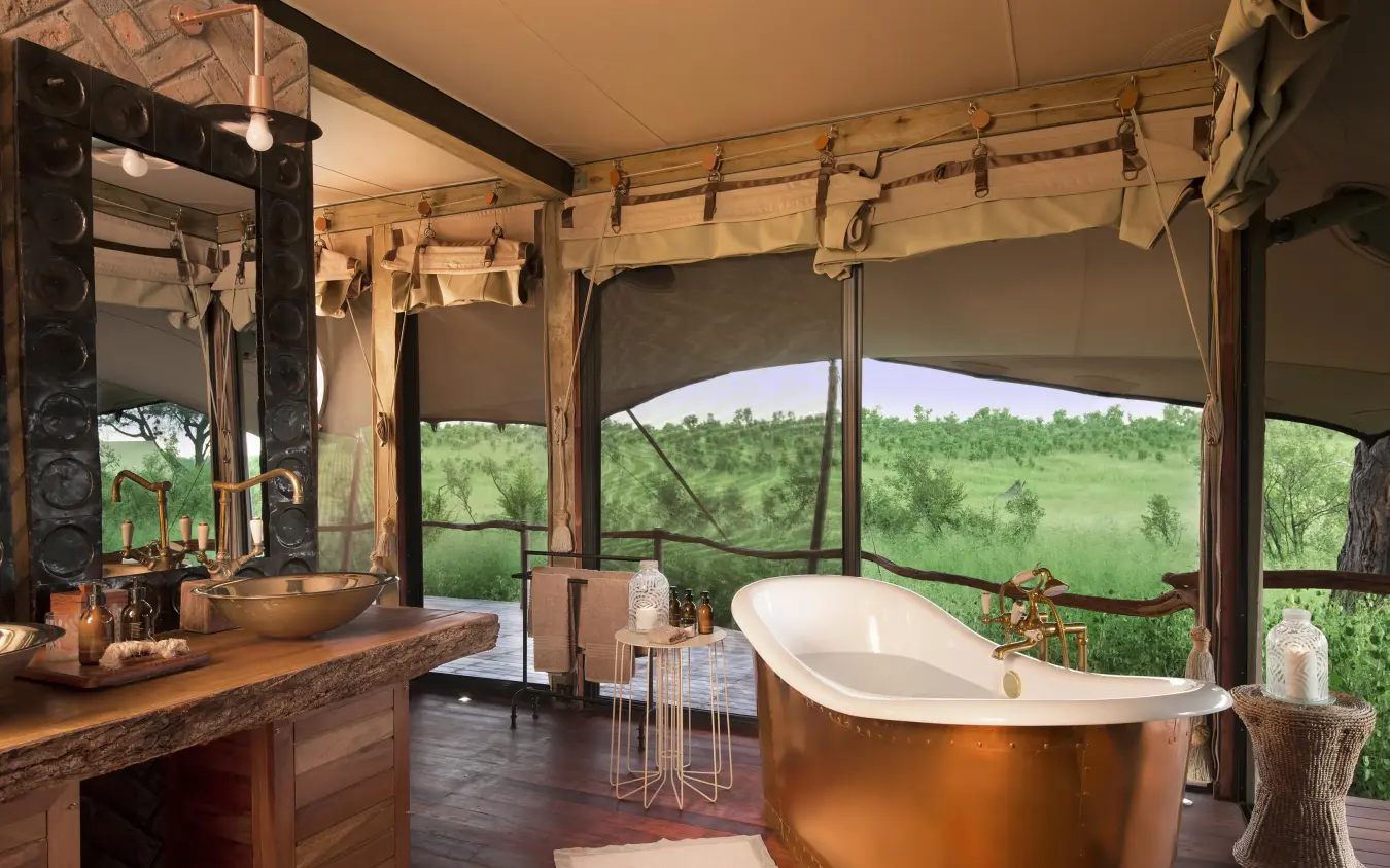Luxury safari bathroom with copper tub overlooking savanna, Somalisa Camp, Hwange National Park, Zimbabwe