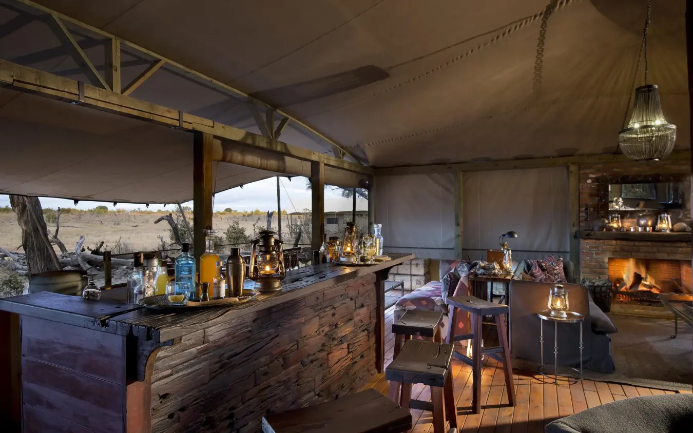 Canvas tent lounge with fireplace and bar setup, Somalisa Expeditions, Hwange National Park, Zimbabwe