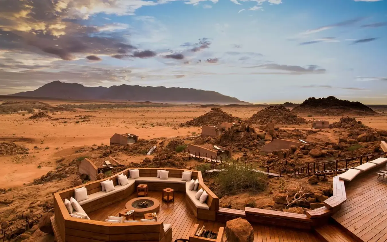 Wooden deck overlooking desert landscape with distant mountain, Sorris Sorris, Damaraland, Namibia