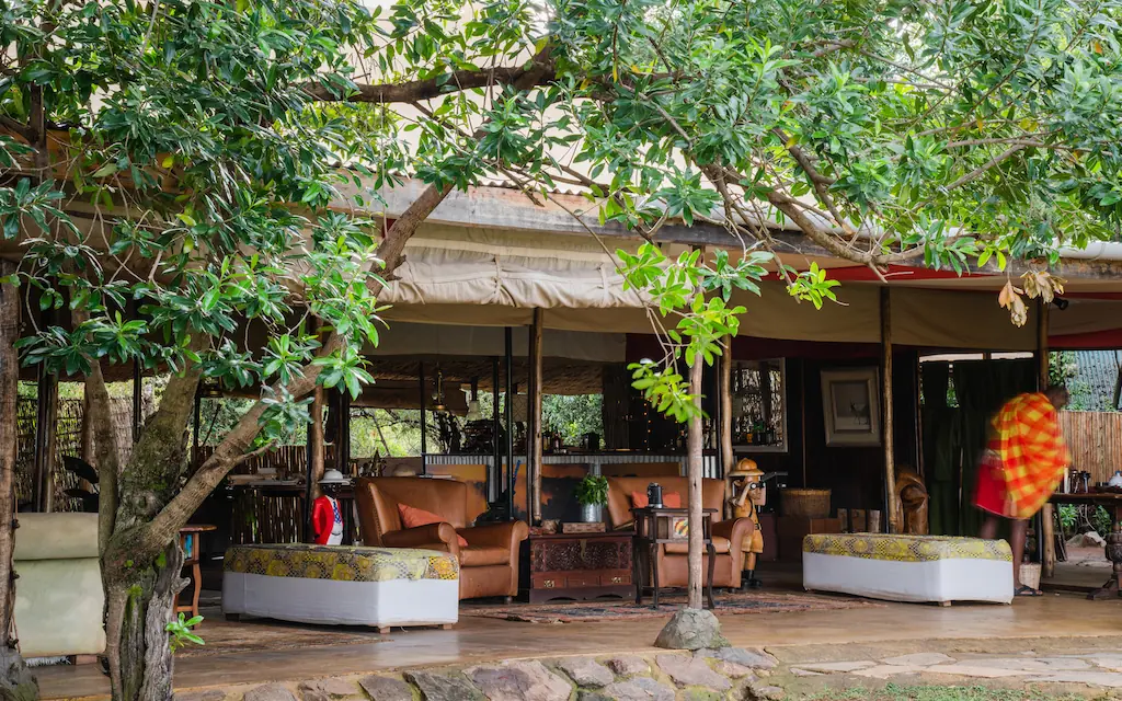 Shaded veranda with seating overlooking natural landscape, Speke’s Camp, Maasai Mara, Kenya