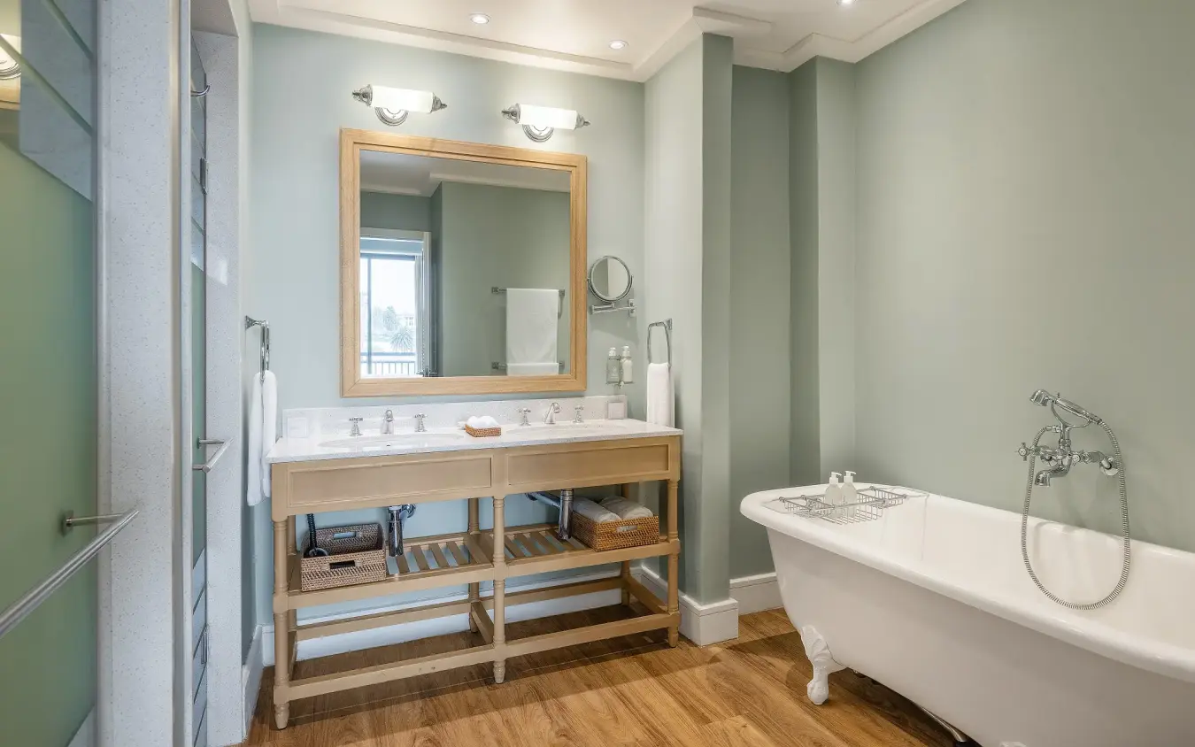 Spa bathroom with freestanding bathtub and wooden vanity, Strand Hotel Swakopmund, Swakopmund, Namibia