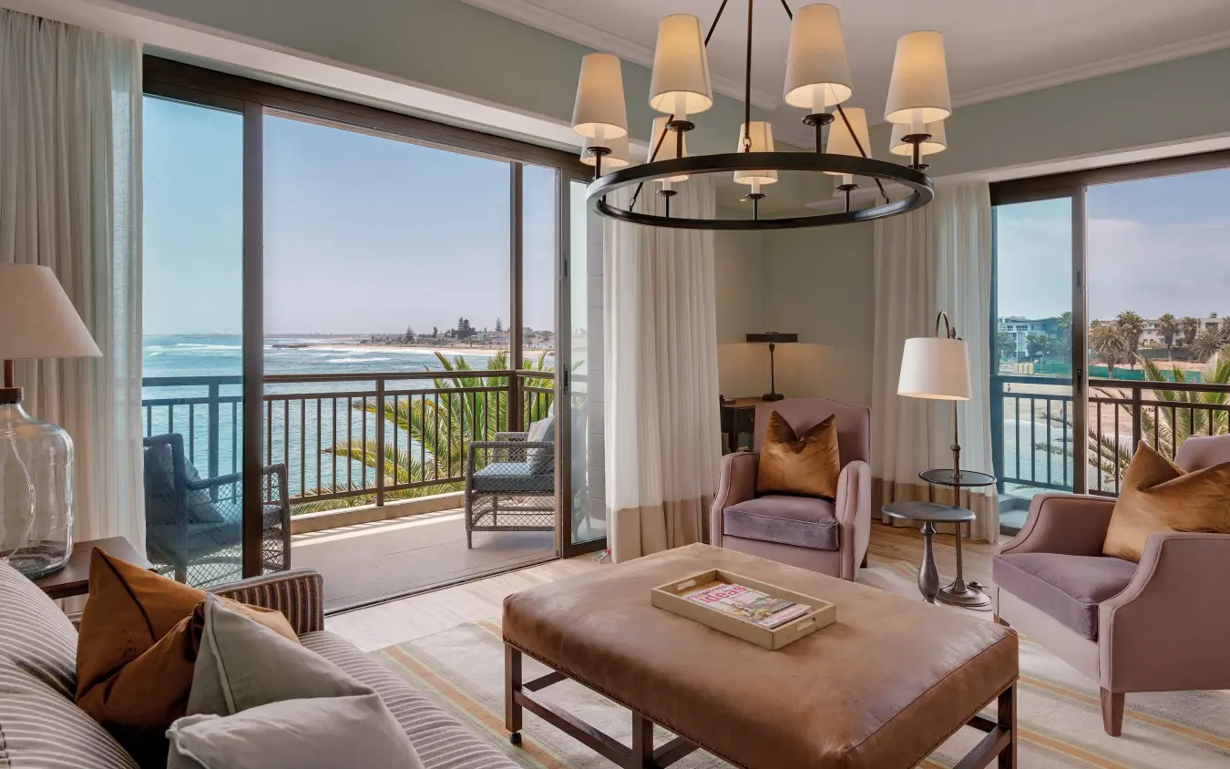 Luxury suite with waterfront views and furnished balcony overlooking bay, Strand Hotel Swakopmund, Swakopmund, Namibia
