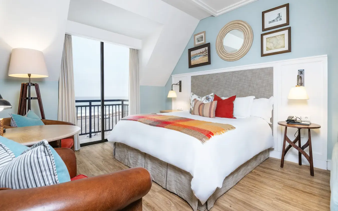 Coastal hotel bedroom with ocean view balcony and nautical décor, Strand Hotel Swakopmund, Swakopmund, Namibia