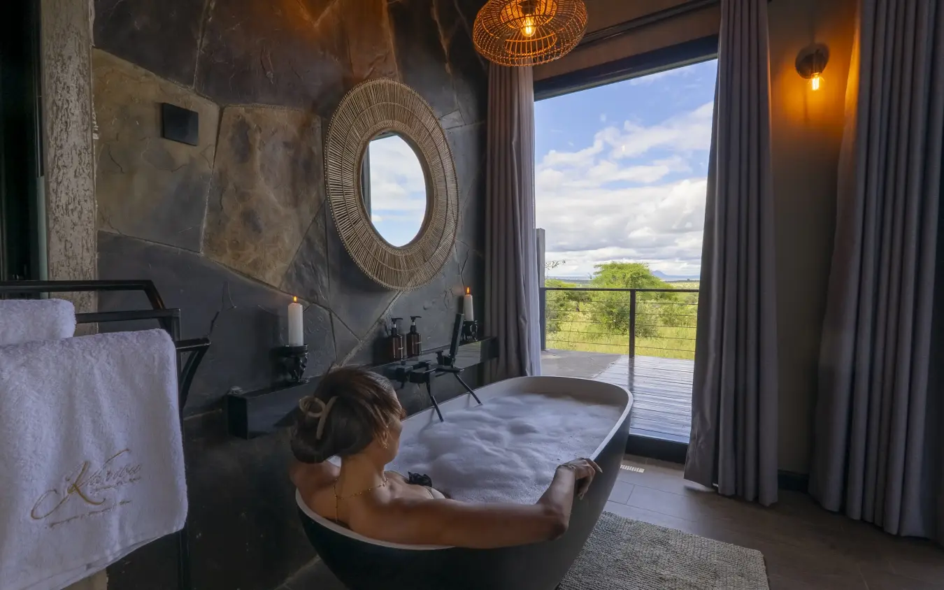 Luxury bathroom with soaking tub overlooking savanna landscape, Tarangire Elephant Springs, Tarangire National Park, Tanzania