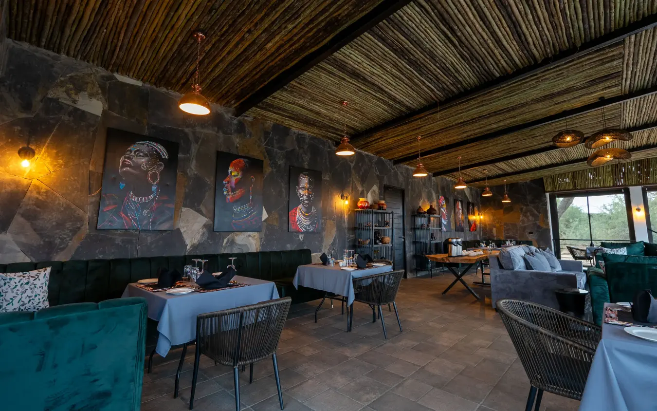 Contemporary dining room with portrait artwork and woven ceiling detail, Tarangire Elephant Springs, Tarangire National Park, Tanzania