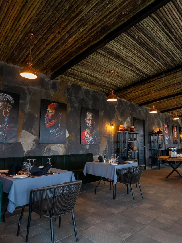 Contemporary dining room with portrait artwork and woven ceiling detail, Tarangire Elephant Springs, Tarangire National Park, Tanzania