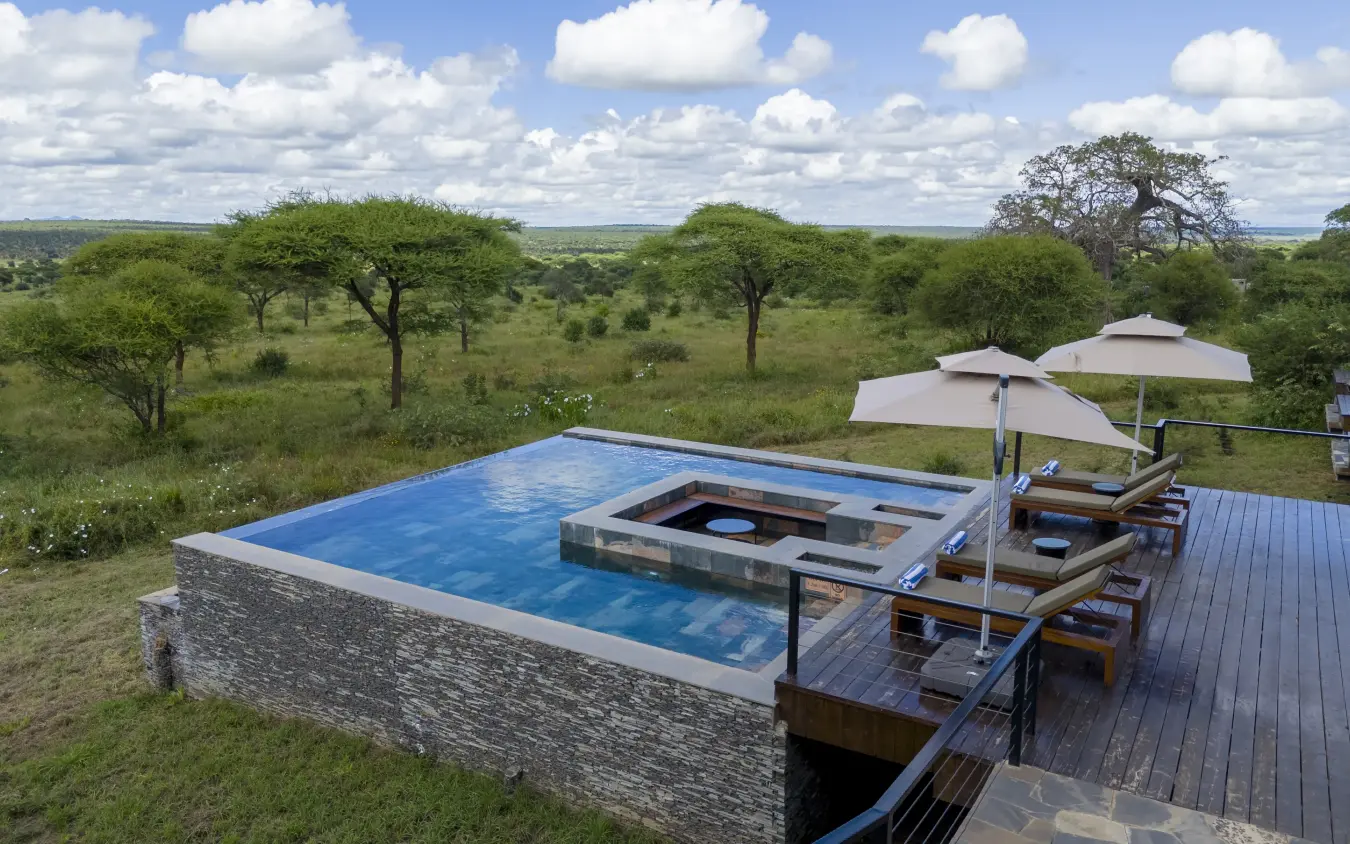 Infinity pool with fire pit overlooking acacia woodland savanna, Tarangire Elephant Springs, Tarangire National Park, Tanzania
