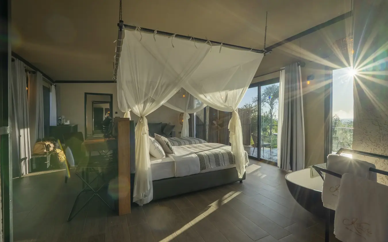 Canopy bed in luxury suite with savanna views and natural light, Tarangire Elephant Springs, Tarangire National Park, Tanzania
