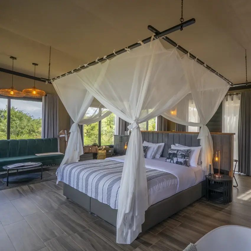 Luxury bedroom suite with canopy bed and savanna views from covered pavilion, Tarangire Elephant Springs, Tarangire National Park, Tanzania