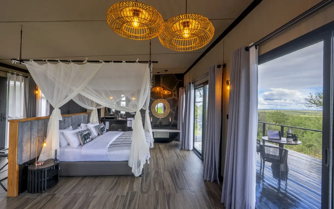 Luxury bedroom suite with four-poster bed and expansive savanna views from terrace, Tarangire Elephant Springs, Tarangire National Park, Tanzania