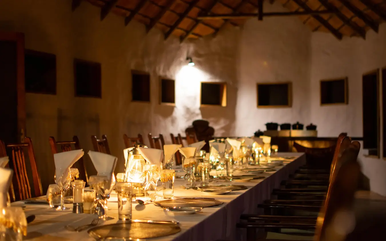 Long dining table set with glassware and place settings, Tau Pan Camp, Central Kalahari, Botswana