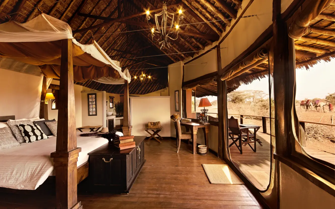 Luxury safari bedroom with four-poster bed and open views, Tawi Lodge, Amboseli and Chyulu Hills, Kenya