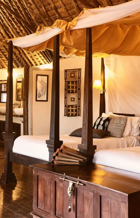 Spacious bedroom with four-poster bed and draped canopy, Tawi Lodge, Amboseli and Chyulu Hills, Kenya