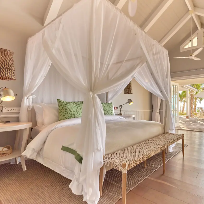 Luxury beachfront bedroom with white canopy bed and ocean views, Thanda Island, Mafia Archipelago, Tanzania