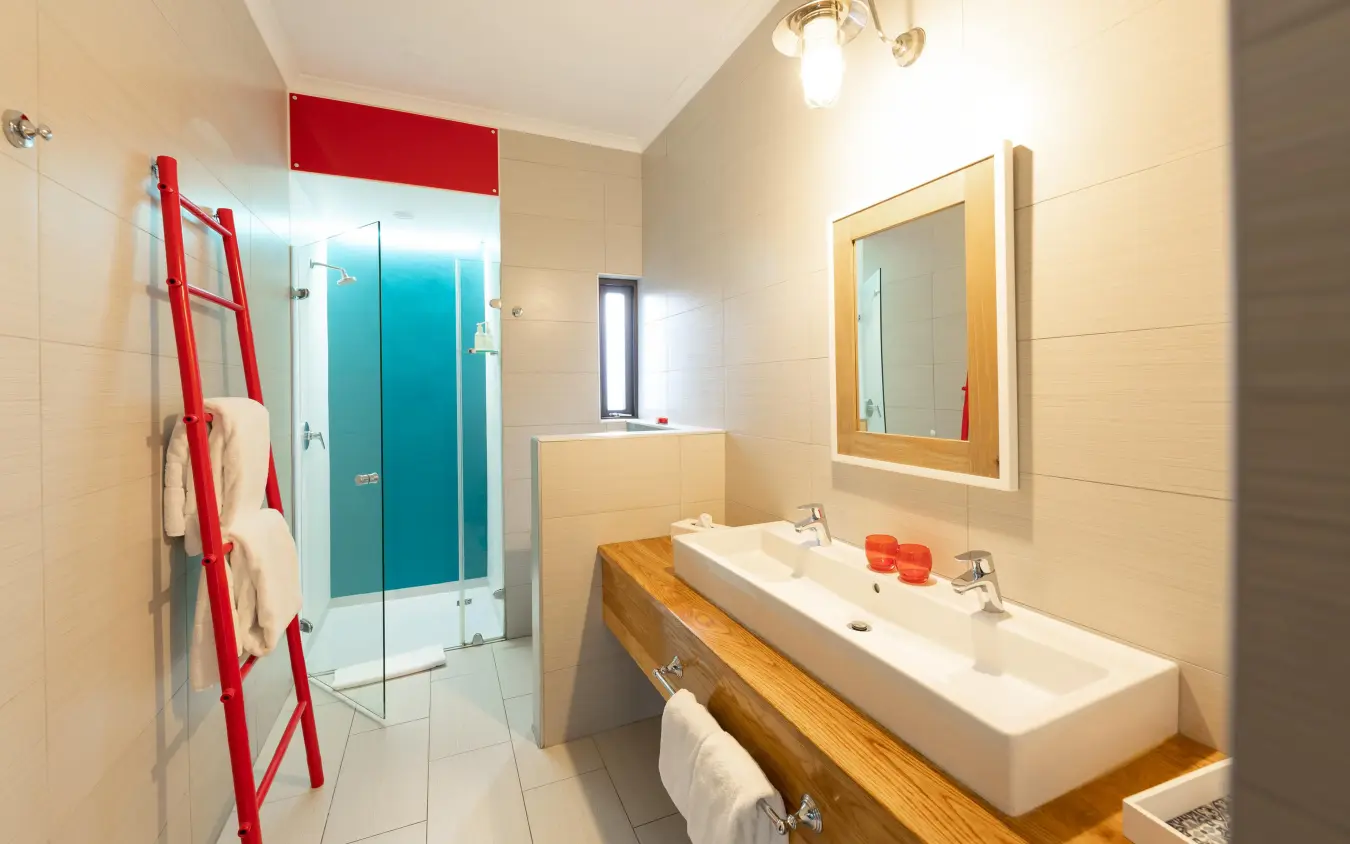 Modern bathroom with double sink and turquoise shower enclosure, The Delight Swakopmund, Swakopmund, Namibia