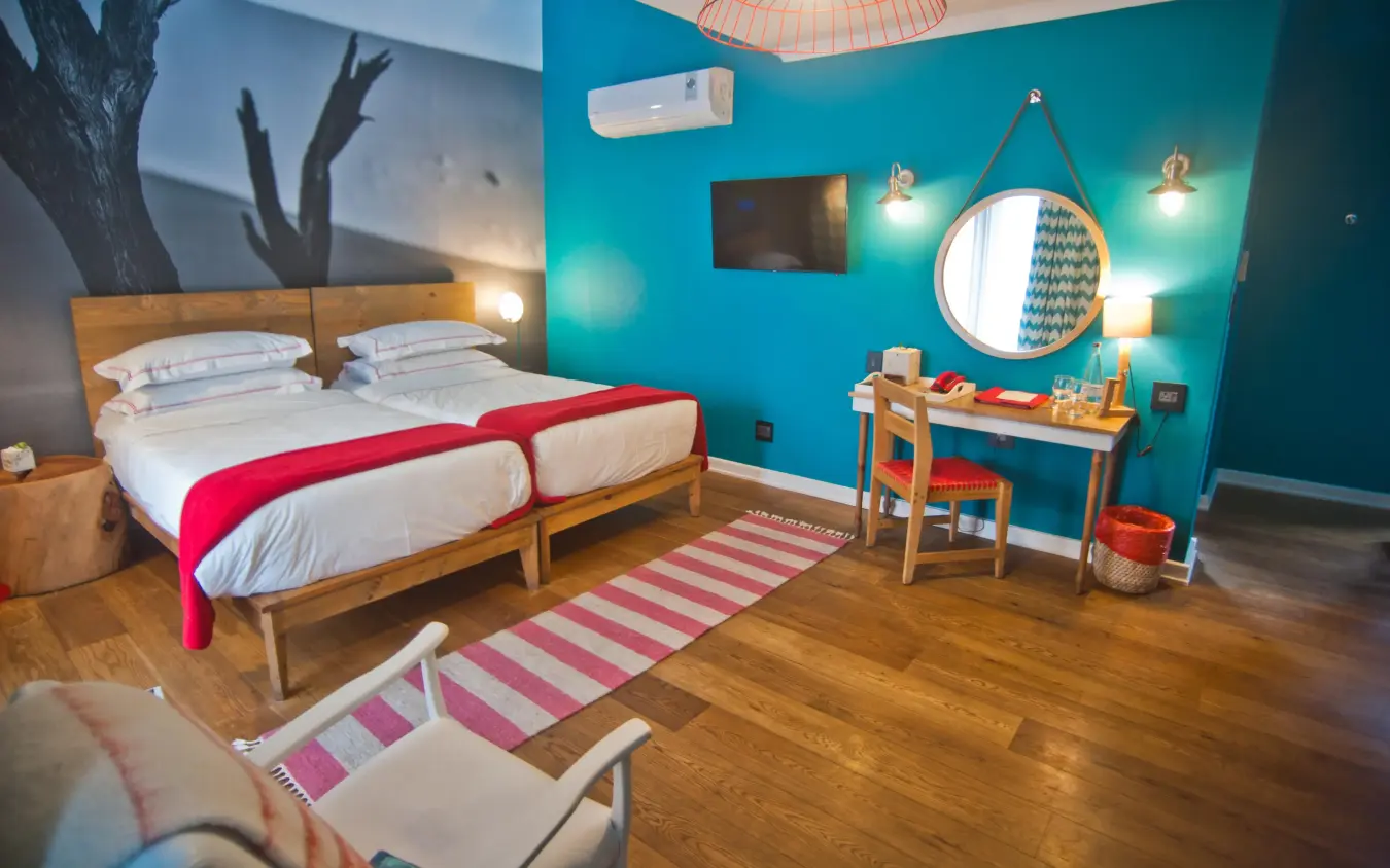 Modern bedroom with turquoise walls and wooden furnishings, The Delight Swakopmund, Swakopmund, Namibia