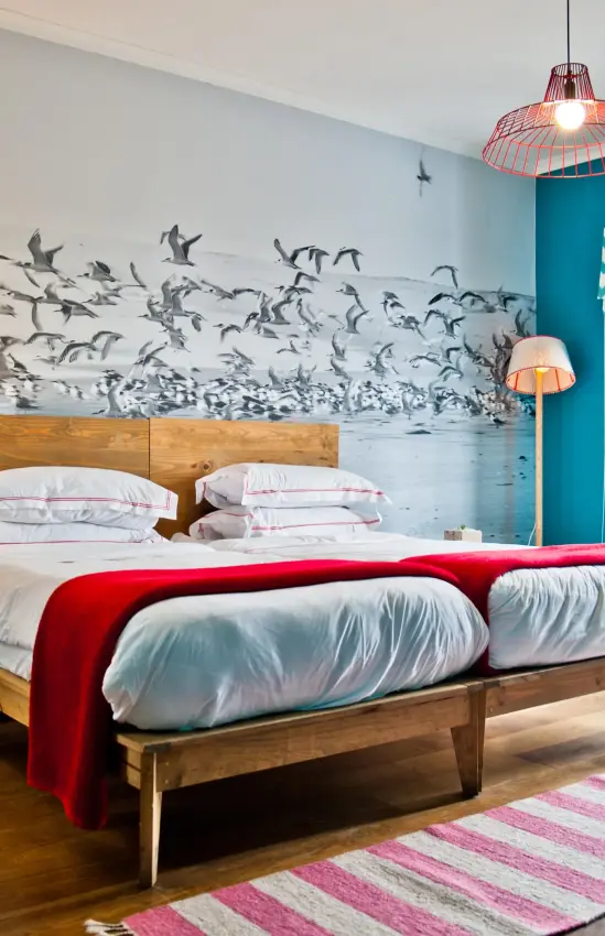 Modern bedroom with wooden bed and turquoise accent wall, The Delight Swakopmund, Swakopmund, Namibia
