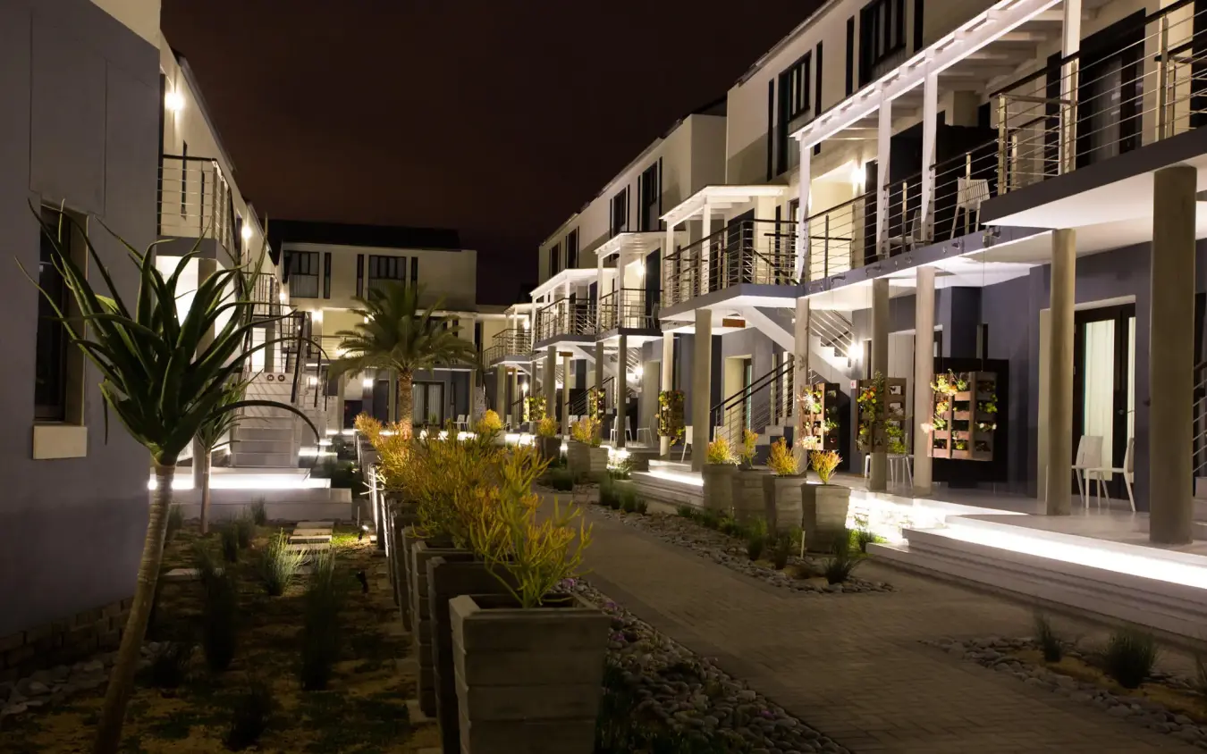 Nighttime view of modern white residential buildings with courtyard, The Delight Swakopmund, Swakopmund, Namibia