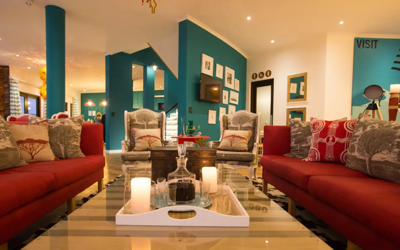 Modern lounge with red sofas and teal architectural features, The Delight Swakopmund, Swakopmund, Namibia
