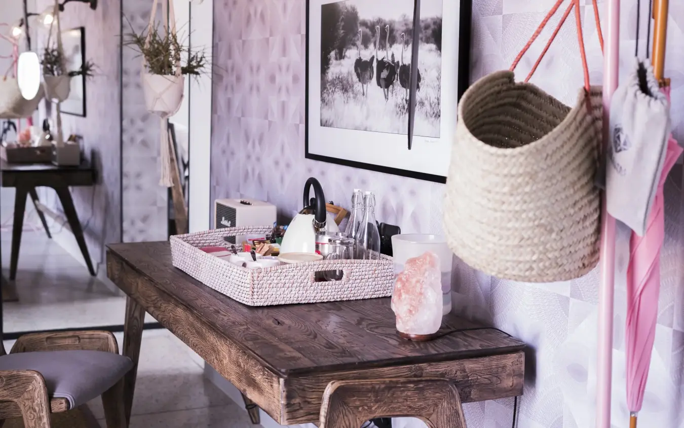 Vanity desk with woven storage basket and beauty products in styled bedroom, The Desert Grace, Sossusvlei, Namibia
