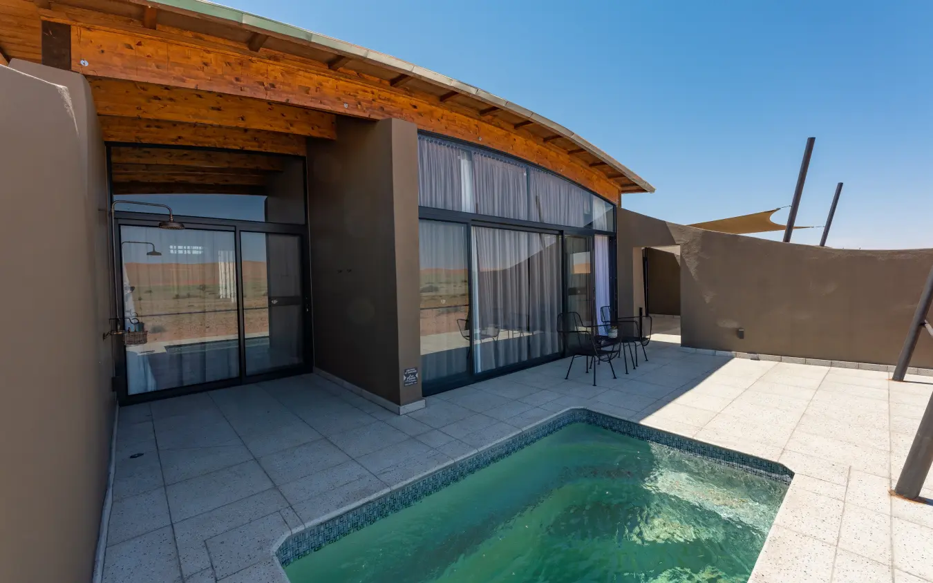 Modern lodge terrace with plunge pool overlooking arid landscape, The Desert Grace, Sossusvlei, Namibia