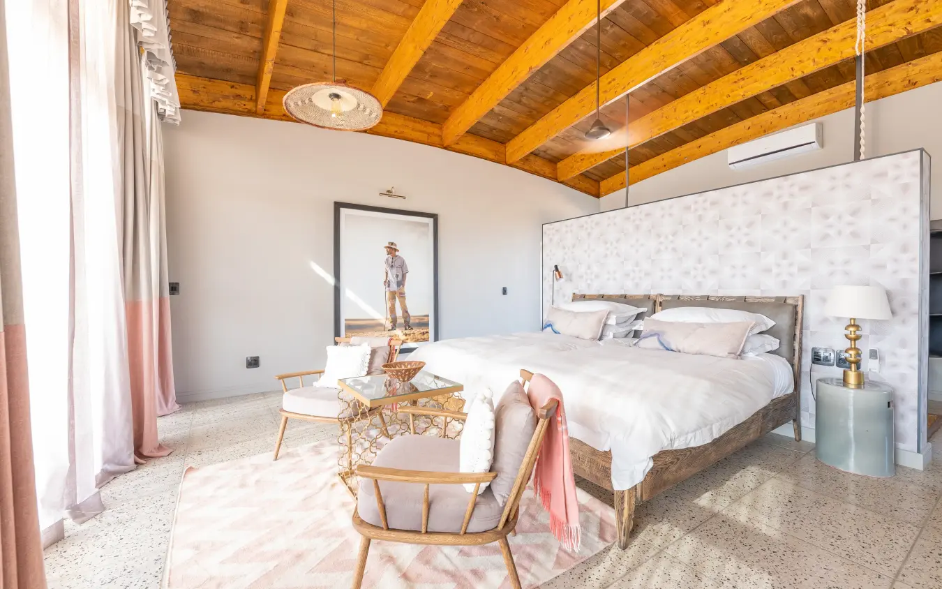 Modern bedroom with exposed wooden beams and minimalist decor, The Desert Grace, Sossusvlei, Namibia