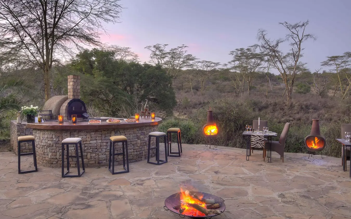 Outdoor entertaining area with fire pit at dusk, The Emakoko, Nairobi, Kenya