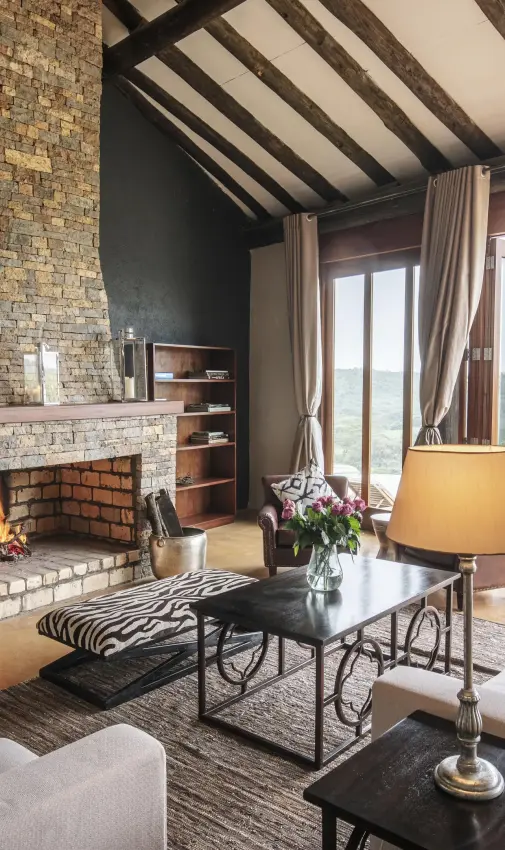 Modern lounge with fireplace overlooking savanna landscape, The Emakoko, Nairobi, Kenya