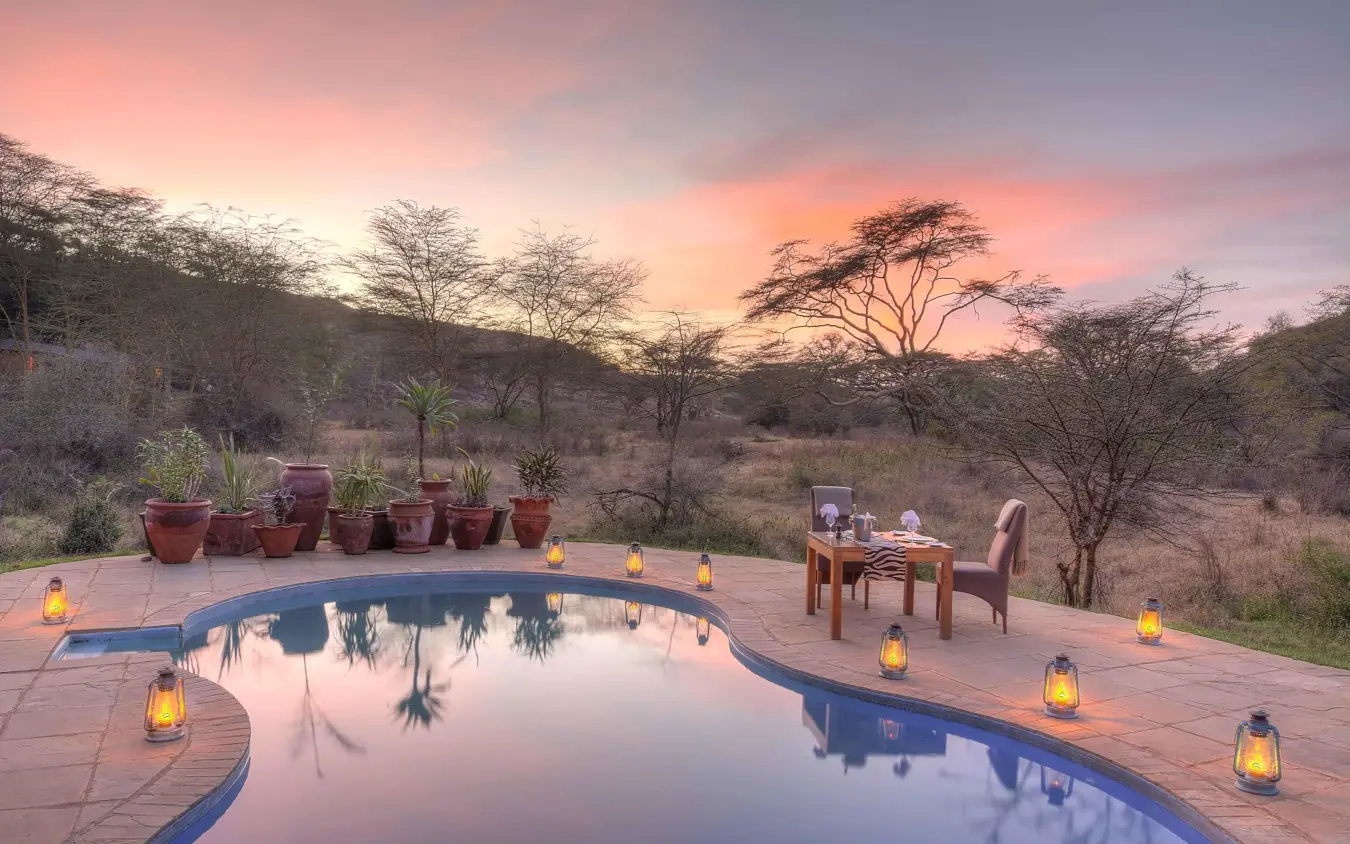 Infinity pool at sunset with savanna landscape beyond, The Emakoko, Nairobi, Kenya