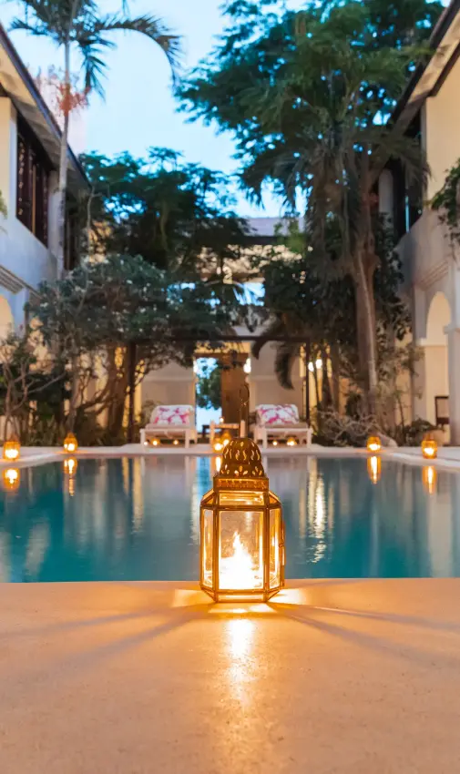 Colonnaded courtyard with reflecting pool and tall trees, The Fort, Lamu Archipelago, Kenya