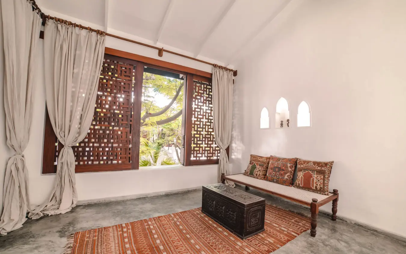 Spacious interior room with wooden screens and bench seating, The Fort, Lamu Archipelago, Kenya