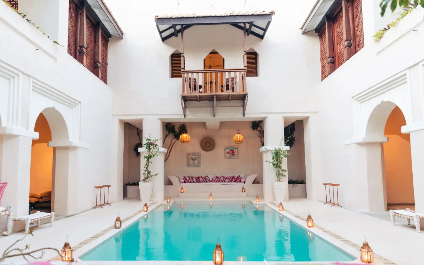 Indoor courtyard pool with white walls and arched doorways, The Fort, Lamu Archipelago, Kenya