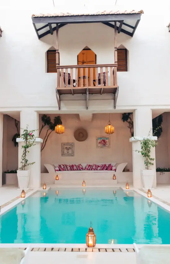Indoor courtyard pool with white walls and arched doorways, The Fort, Lamu Archipelago, Kenya
