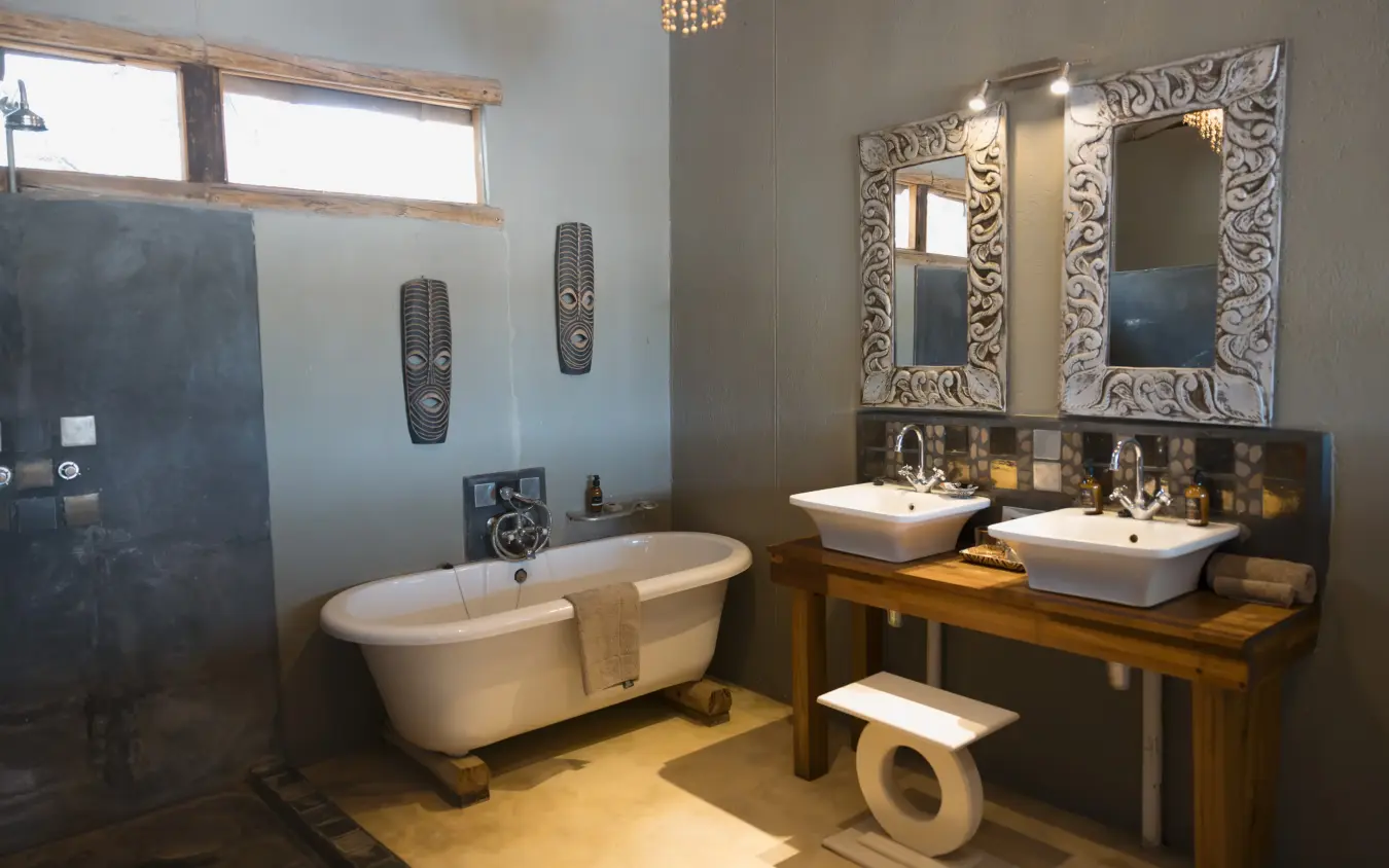 Luxury bathroom with freestanding bathtub and dual vessel sinks, The Hide, Hwange National Park, Zimbabwe