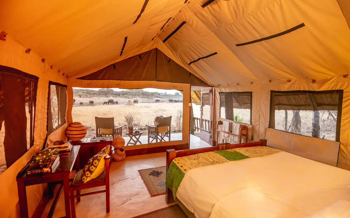 Luxury safari tent interior with beds overlooking wildlife viewing area, The Hide, Hwange National Park, Zimbabwe