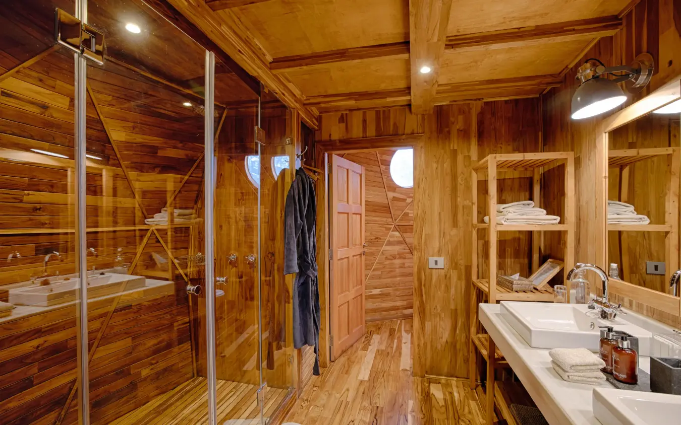 Luxury wooden bathroom with glass shower enclosure and double vanity, The Highlands, Ngorongoro Crater, Tanzania