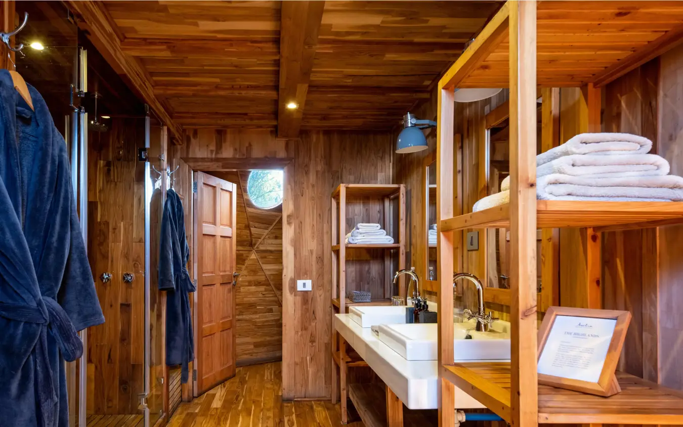 Wooden bathroom interior with vanity sink and shelving, The Highlands, Ngorongoro Crater, Tanzania
