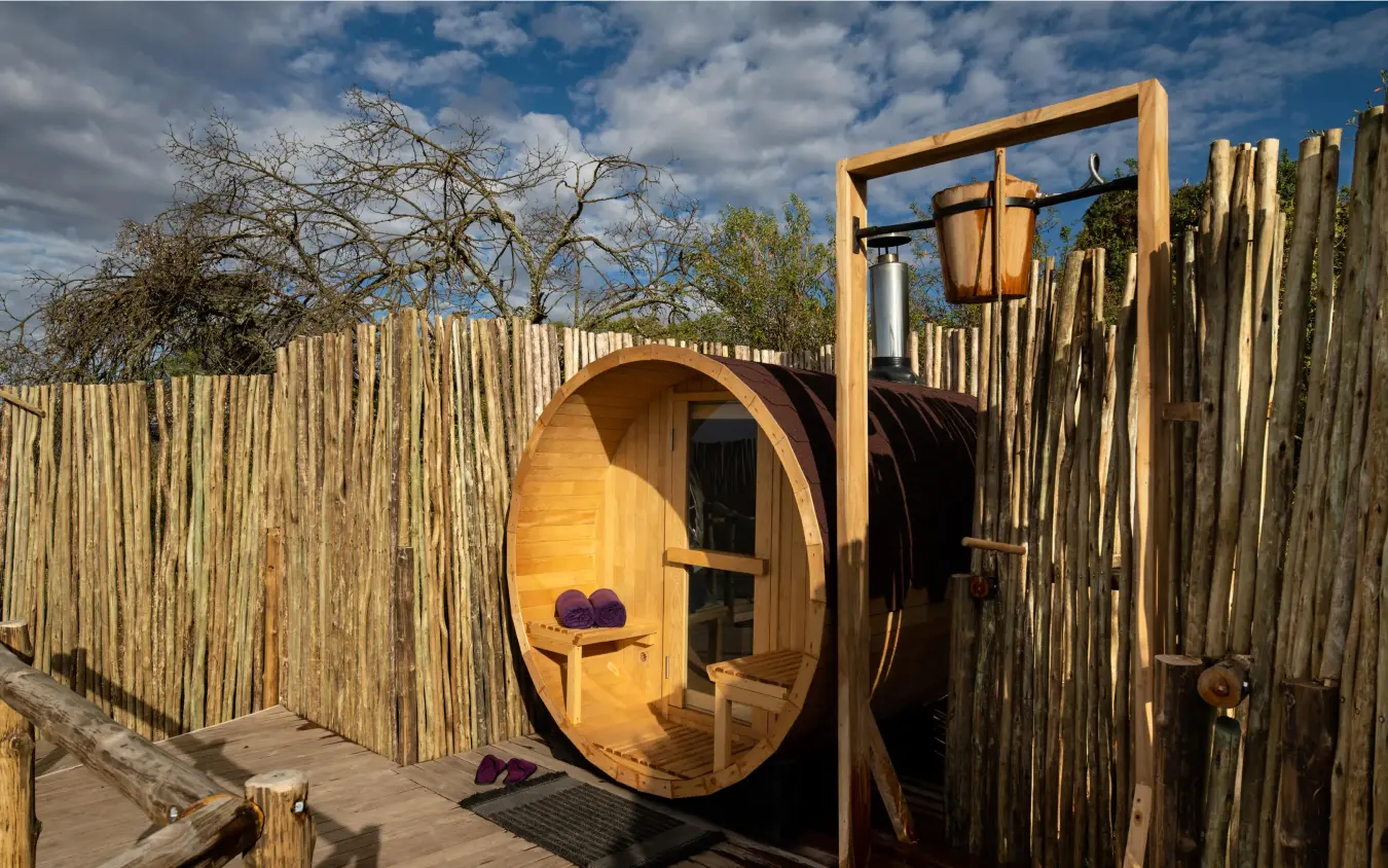 Wooden barrel sauna with entrance door in enclosure, The Highlands, Ngorongoro Crater, Tanzania