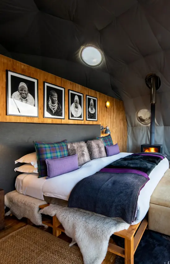 Geodesic dome bedroom with panoramic landscape views and fireplace, The Highlands, Ngorongoro Crater, Tanzania