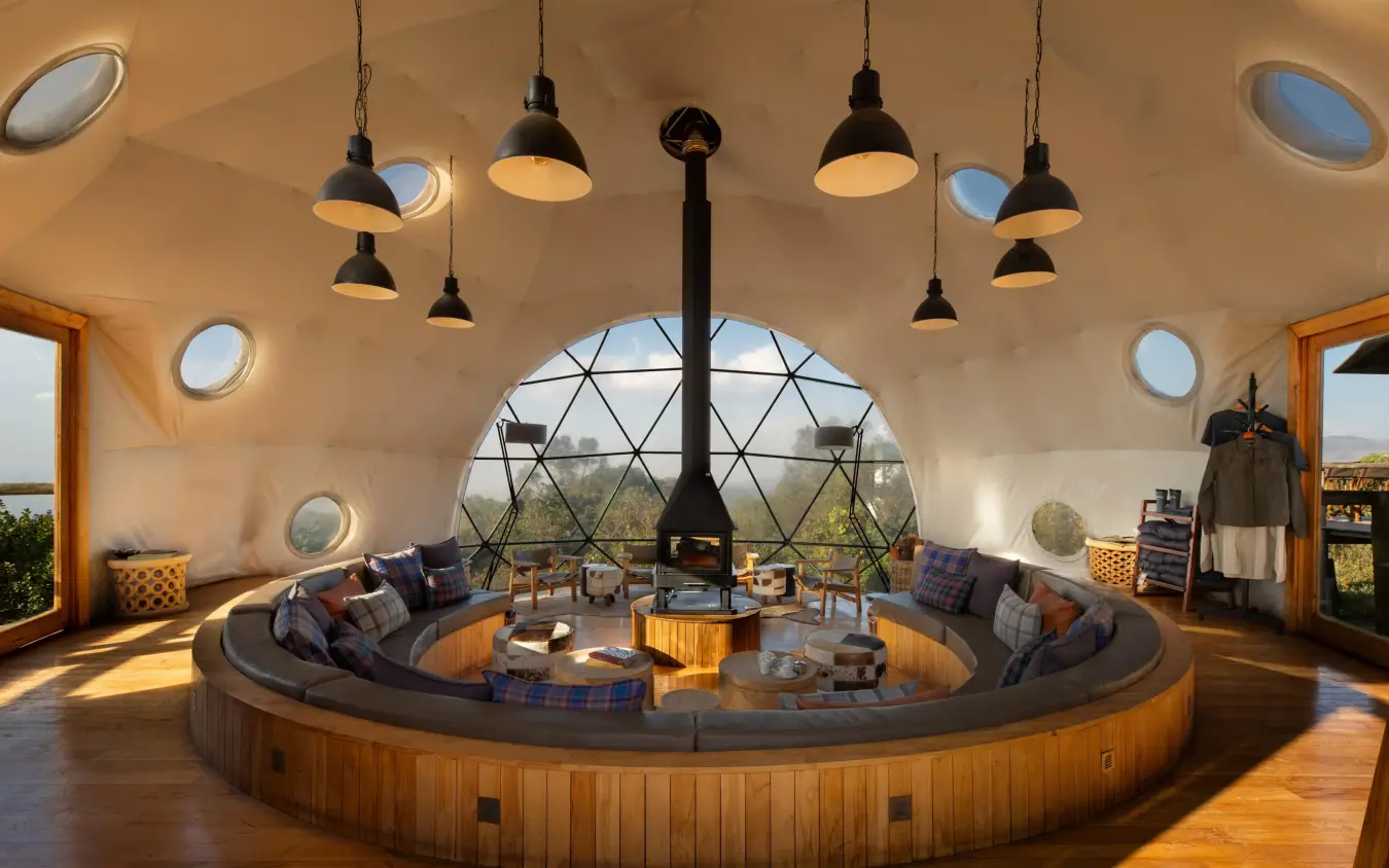 Circular lounge with central fireplace and geodesic dome ceiling, The Highlands, Ngorongoro Crater, Tanzania