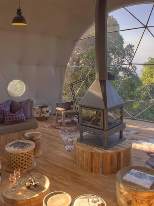 Geodesic dome interior with seating and forest views, The Highlands, Ngorongoro Crater, Tanzania