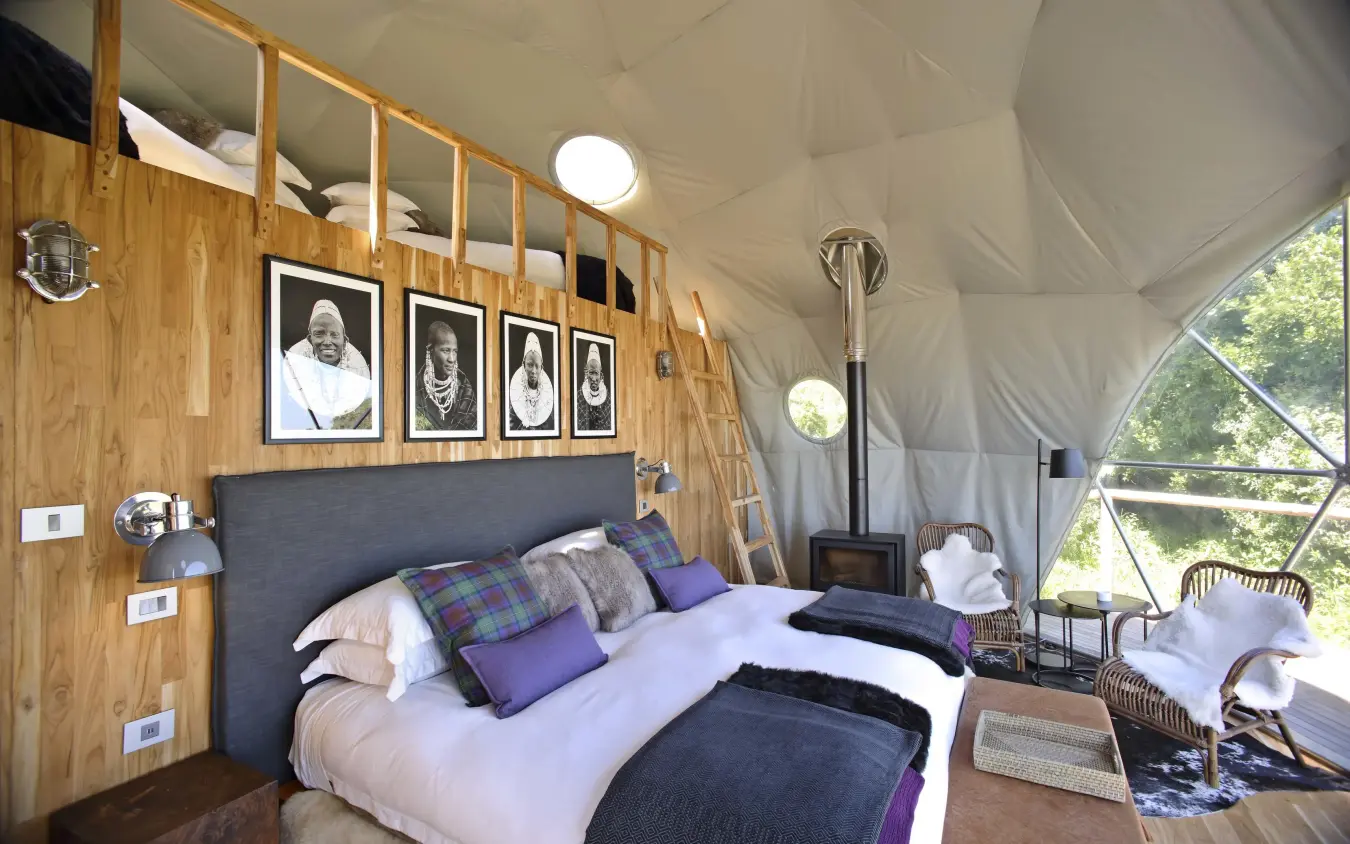Luxury glamping tent bedroom with wooden interior and canvas walls, The Highlands, Ngorongoro Crater, Tanzania