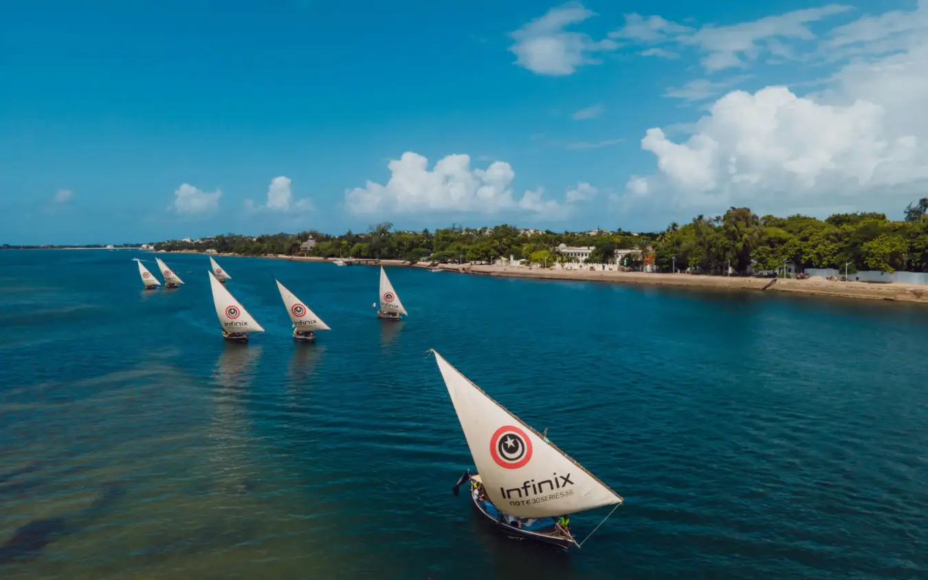 Traditional sailing dhows moored in shallow turquoise water, The Majlis Resort, Lamu Archipelago, Kenya