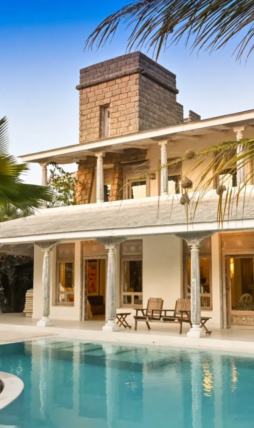 Resort pool with colonial architecture and palm trees, The Majlis Resort, Lamu Archipelago, Kenya