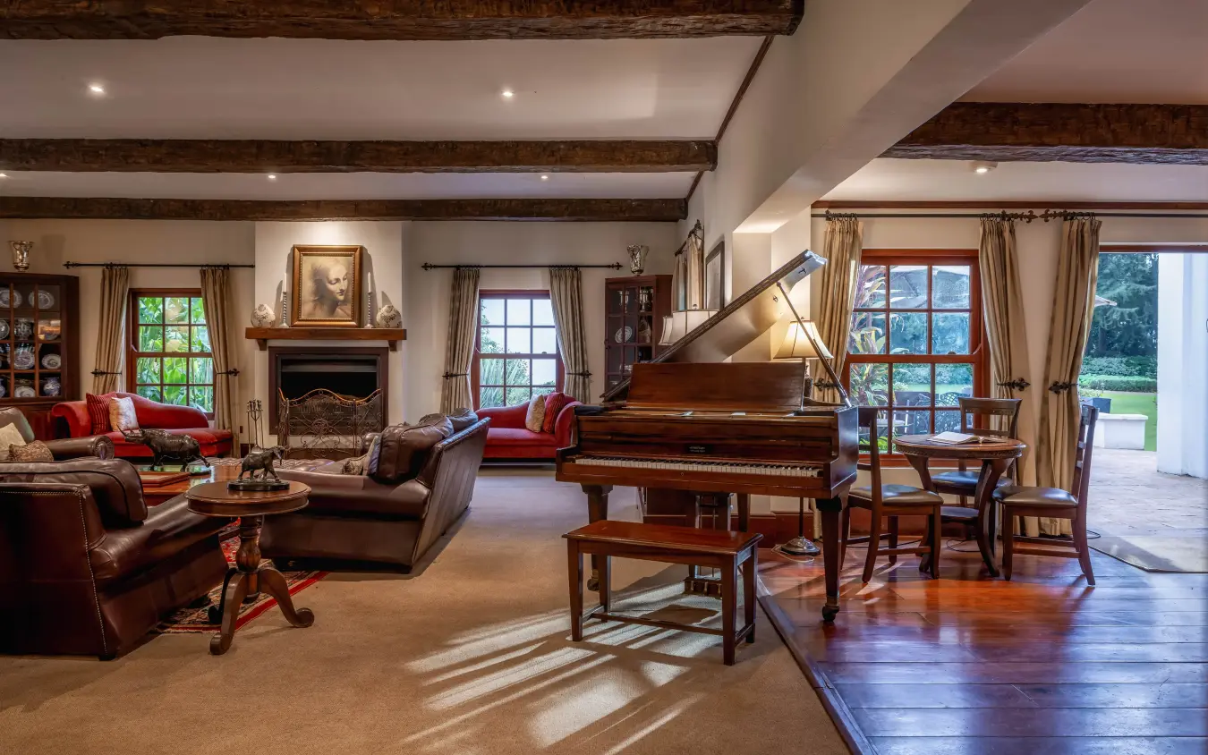 Grand piano in luxury manor living room with leather furnishings, The Manor at Ngorongoro, Ngorongoro Crater, Tanzania