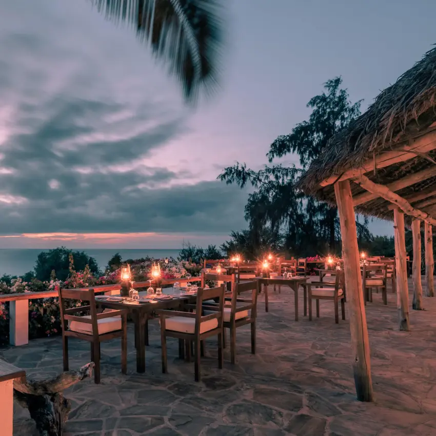 Waterfront dining deck at sunset with ocean view, The Manta Resort, Zanzibar & Pemba, Tanzania