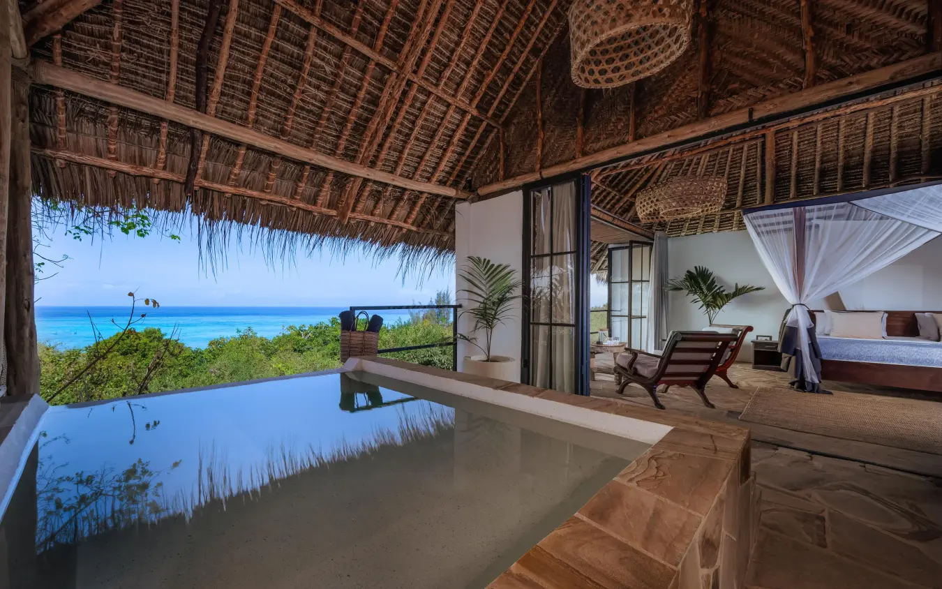 Overwater bungalow bedroom with ocean view and infinity pool, The Manta Resort, Zanzibar & Pemba, Tanzania
