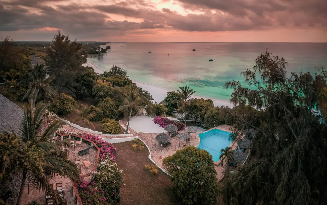 Beachfront resort with pool overlooking tropical waters and boats, The Manta Resort, Zanzibar & Pemba, Tanzania