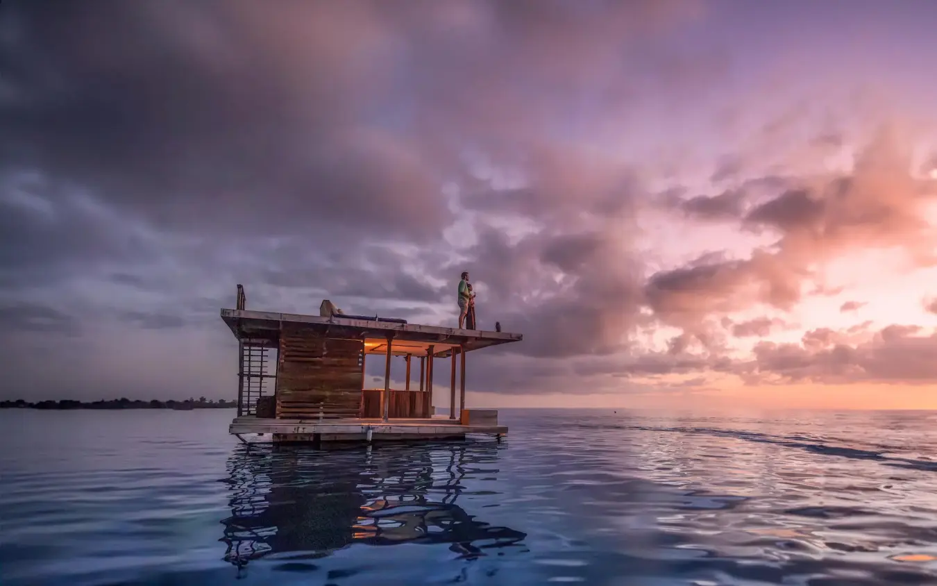 Wooden overwater bungalow at sunset with dramatic sky, The Manta Resort, Zanzibar & Pemba, Tanzania